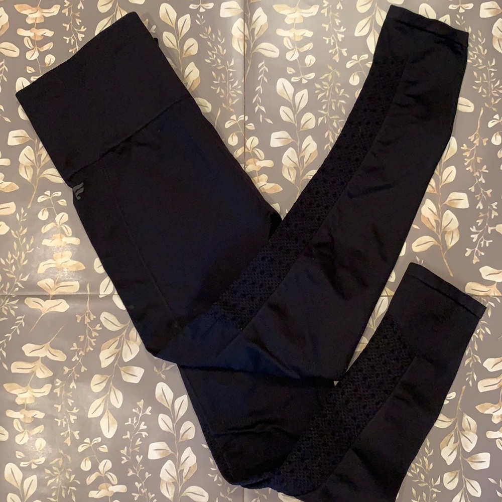 Fabletics leggings. Black. Design on lower leg. Small.